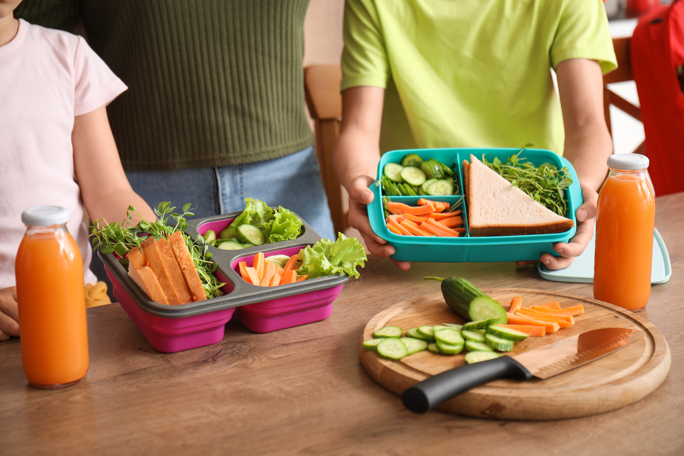 Mother and Her Little Children with School Lunch Boxes in Kitchen, Closeup